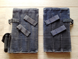 Backside of pouches with metal tips on straps. Unknown factory code